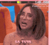 a blurred image of a woman with the words la tuya on the bottom right