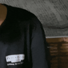 a person wearing a black shirt that says ' plein ' on it