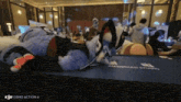 a person in a furry costume is laying on a table in a room .