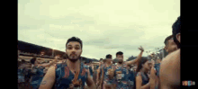 a group of people are dancing in a crowd of people .