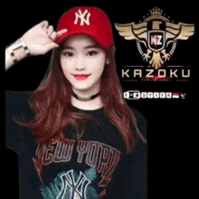 a woman wearing a red hat and a black shirt is standing in front of a kazoku logo .
