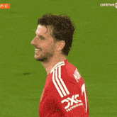 a man in a red shirt with the word x on his sleeve