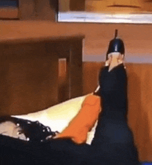 a person is laying on a bed in a room with a lamp hanging from the ceiling .