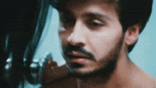 a close up of a man with a beard and a woman touching his face .