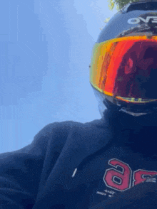 a person wearing a motorcycle helmet and goggles is looking at the camera .