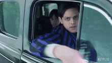 a boy in a car with netflix written on the side of it