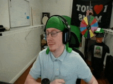 a man wearing headphones stands in front of a sign that says i love you