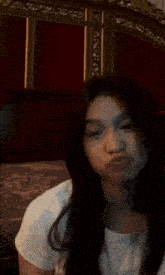 a young woman is making a funny face and giving a thumbs up