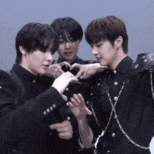 a group of young men are making a heart shape with their fingers