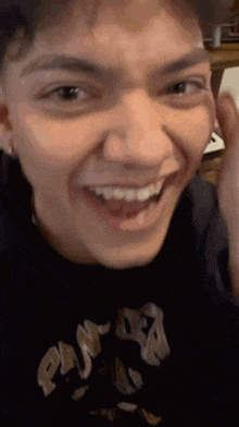 a close up of a man 's face with his mouth open and his teeth showing .