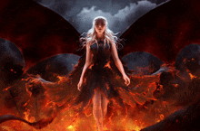 a woman in a black dress with red wings is surrounded by flames