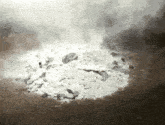 a pile of rocks is being burned with smoke coming out of the top