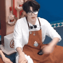 a man wearing glasses and an apron with a badge that says ' ufc ' on it
