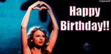 a woman making a heart shape with her hands and the words happy birthday