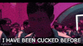 a man is standing in front of a crowd with the words `` i have been cucked before '' written on the screen .