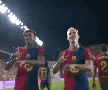 two soccer players are dancing on a field and one has the number 22 on his jersey
