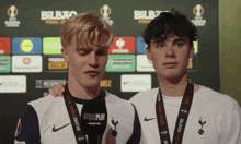 two boys wearing medals that say bilbao final