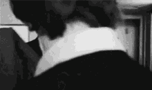 a black and white photo of a man 's neck and shoulder .