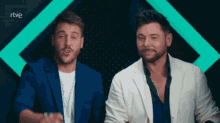 two men are standing next to each other with the letters rtve on the bottom