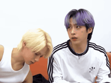 a boy with purple hair and a white adidas shirt