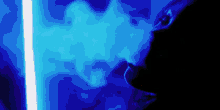 a person is smoking a hookah in a dark room with a blue light behind them .