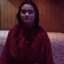a woman in a red dress is making a funny face .
