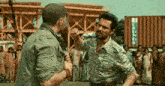 a man in a zebra print shirt is fighting another man in front of a crowd of people .