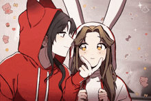 a girl in a red hoodie is kissing another girl in a white bunny hat