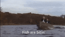 a man in a tuxedo is sitting in a boat on a lake and says fish are bitin '
