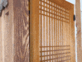 a close up of a wooden door with a grid pattern