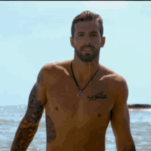 a shirtless man with a tattoo on his chest that says ' a ' on it