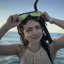 a woman wearing a diving mask has a wristband that says ' o'neill ' on it