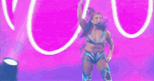 a woman in a metallic outfit is dancing on a colorful stage