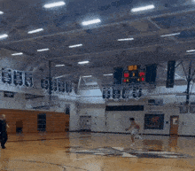 a basketball player is jumping in the air in front of a sign that says this is friar nation