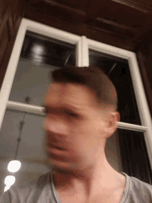 a blurry picture of a man 's face with his eyes closed