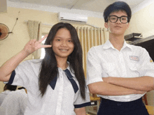 a boy and a girl are posing for a picture and the girl has braces on her teeth