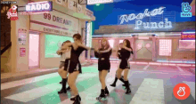 a group of young women are dancing in front of a sign that says 99 dreams