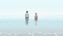 a man and a woman standing on a beach with the words " the beach is very nice " below them
