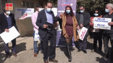 a group of people wearing face masks are holding signs that say mejor maldonado