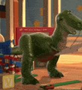 a toy dinosaur from toy story is standing on a wooden floor next to a letter v block