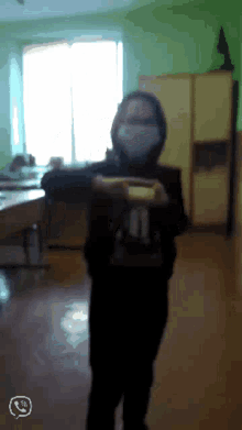 a person wearing a mask with the number 11 on the back