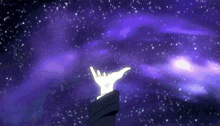 a person 's hand is reaching out towards a purple background with stars