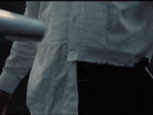 a man in a white shirt is holding a metal bar