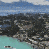 an aerial view of a tropical island with a boat in the foreground