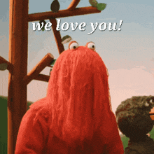 a sesame street character says we love you in white letters