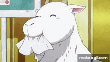 a white goat with horns is eating a piece of paper .