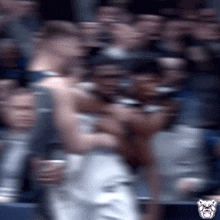 a blurry picture of a crowd of people with a bulldog head in the corner