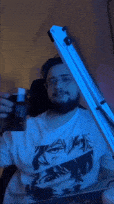 a man wearing a raven shirt is holding a glass