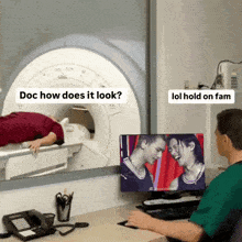 a man laying in a mri machine with a picture of a man and a woman on the monitor