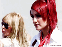 a woman with red hair is next to another woman